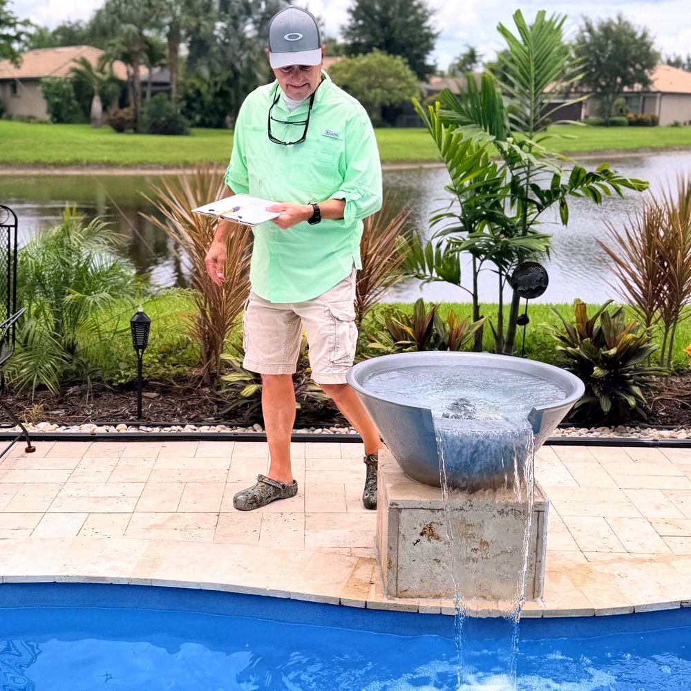Home Watch Reporter with a checklist observing a pool and water feature