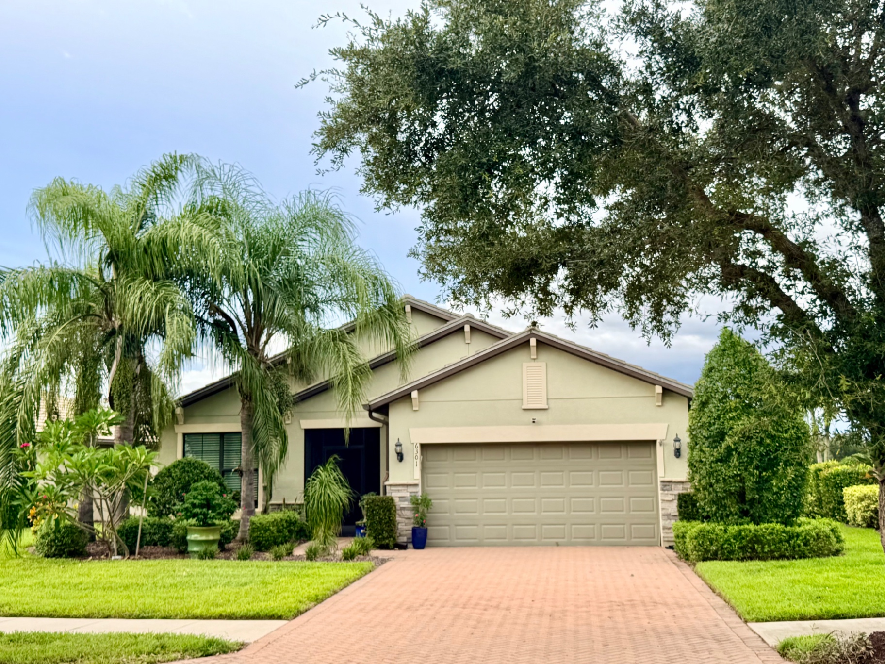 Single-story home with barrel tile roof and paver driveway in Del Webb Naples, Ave Maria, Florida